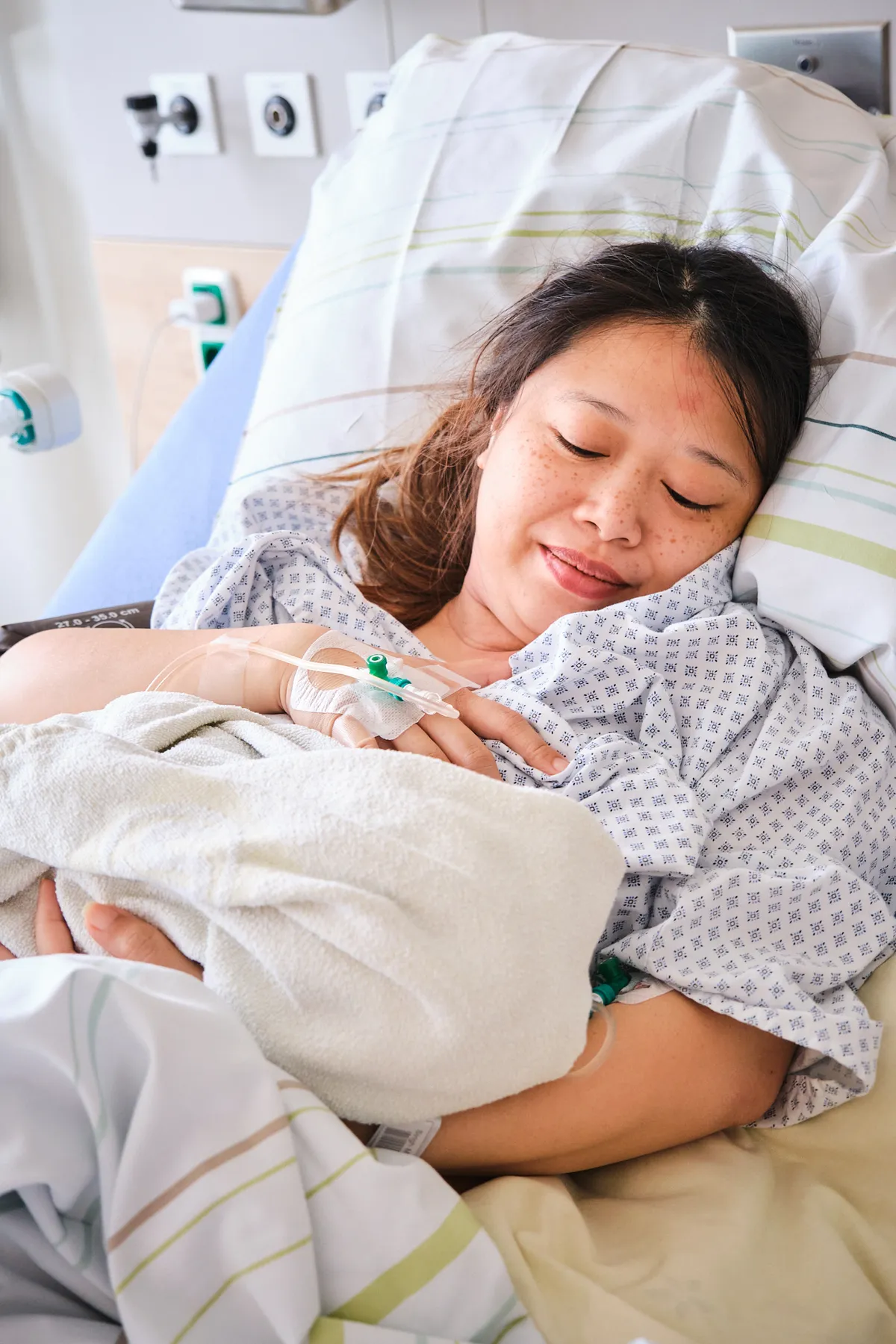 Mother cradling her newborn moments after birth