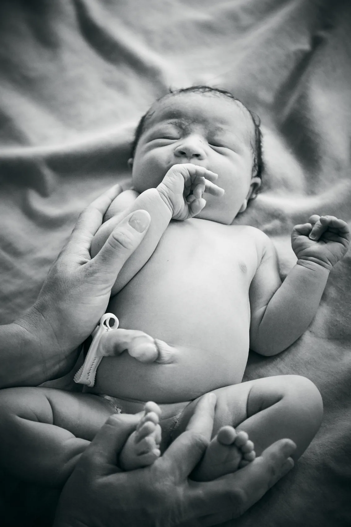 Close-up of a newborn's first breath moments after delivery
