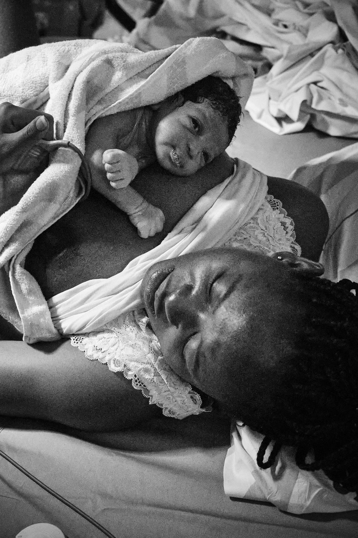 Mother in labour leaning on a birthing ball for support