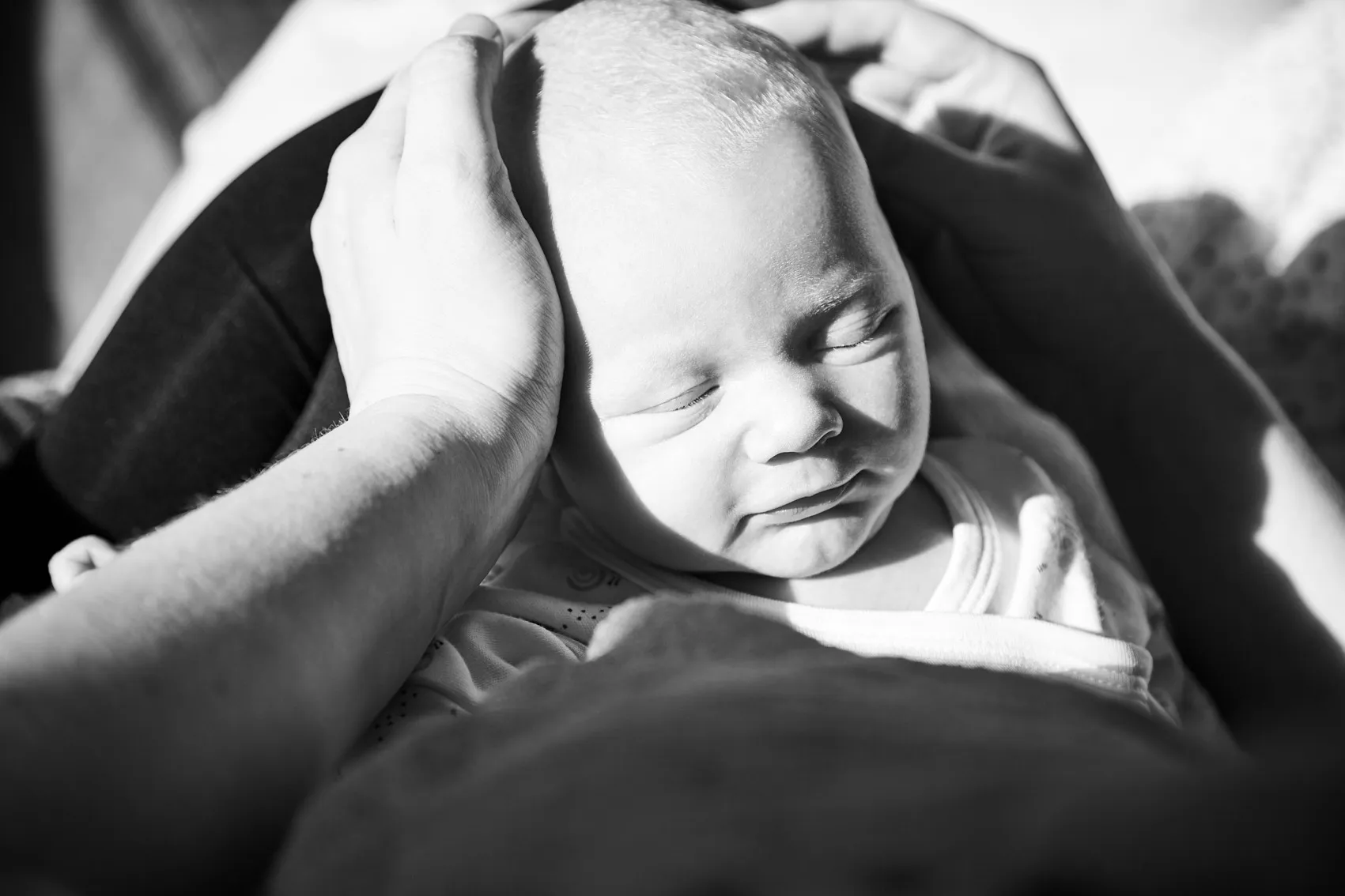 Newborn baby resting peacefully in a swaddle